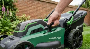 A close-up shot of a person's hand adjusting a single central lever for a 1 to 6 stage height adjustment on a cordless lawnmower.