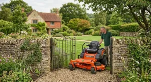 Compact ride-on lawn mower passing easily through a standard British garden gate.