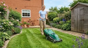 Lightweight electric lawn mower under 100 pounds being pushed easily on a suburban back garden