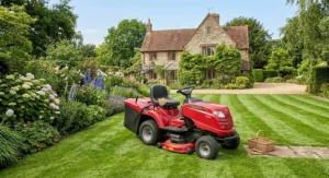 A modern petrol ride on mower parked neatly on a well-maintained lawn in the UK.