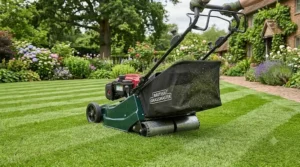 A petrol lawn mower with roller showing a large grass collector bag attached to the rear of the machine.