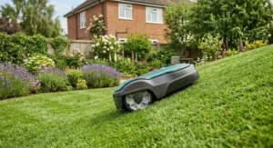 A powerful robot lawn mower easily maintaining a steep grassy slope in a large garden.