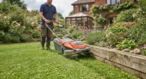 Trimming grass neatly along a garden border using the best hover mower.