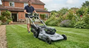 Battery-powered cordless self-propelled lawn mower operating on green grass.
