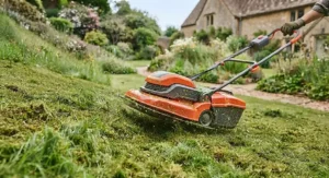 Illustration of an electric hover mower for slopes being used on a grassy embankment.