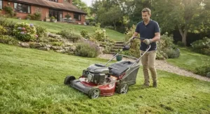 Petrol self-propelled lawn mower navigating a sloped residential lawn.