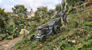 Professional-grade self-propelled lawn mower designed for heavy-duty use on uneven garden slopes.