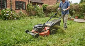 A sturdy rotary mower efficiently cutting longer, thicker grass in a typical UK garden.